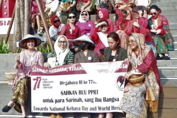 Perempuan berkebaya merah dan berkain Nusantara.